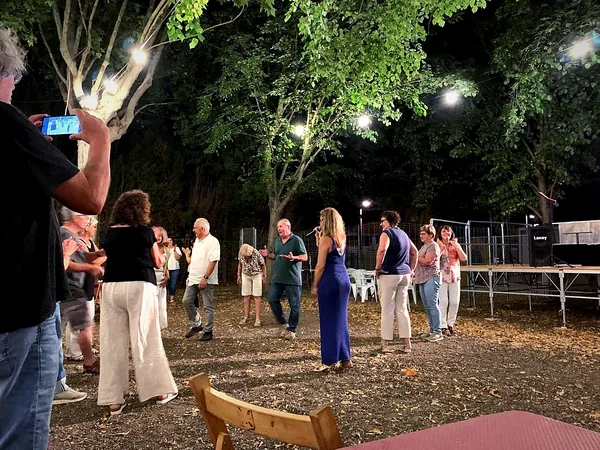Guests dancing in a garden during a performance